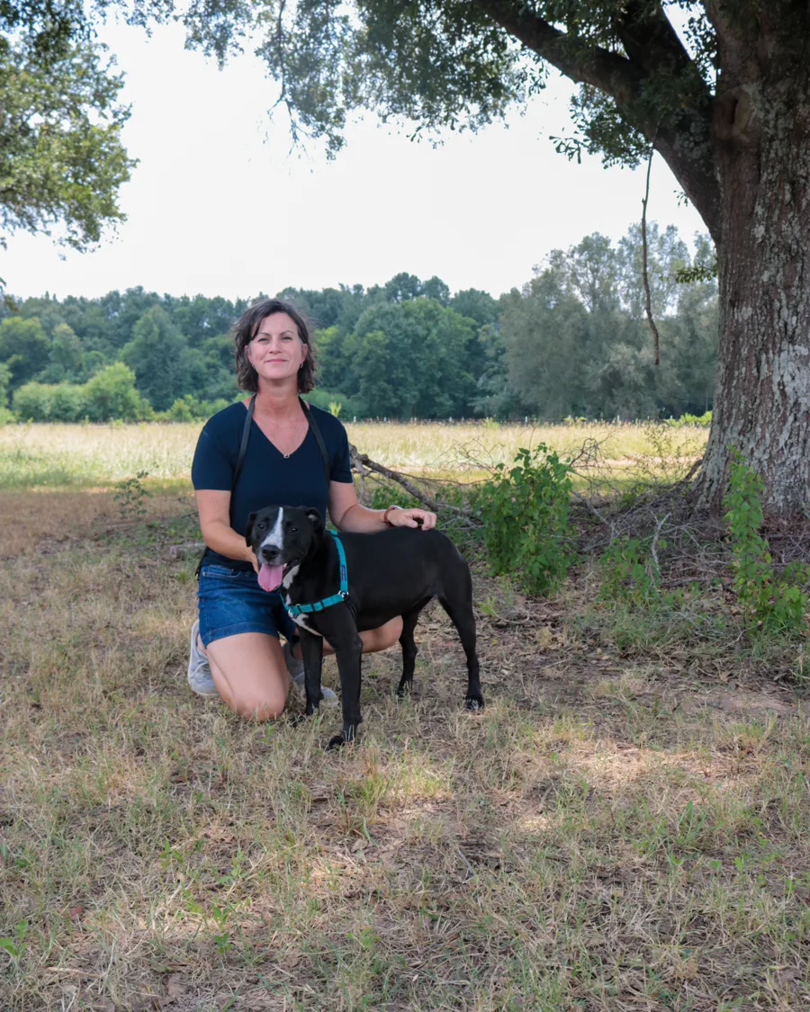 Lily with her caregiver under the oak tree at Southern Paws Farms